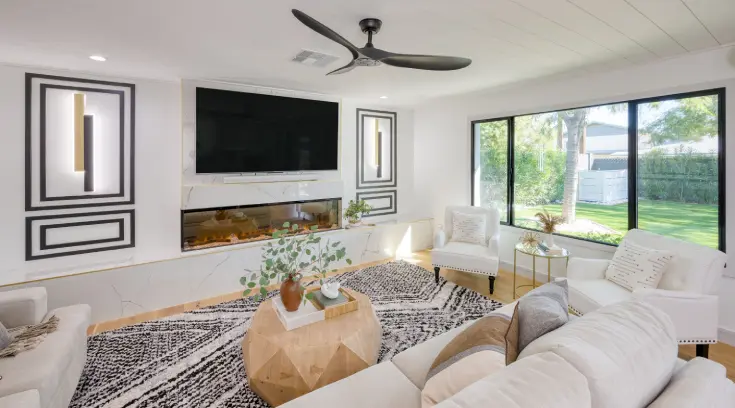 A living room with a fireplace and a large screen tv.