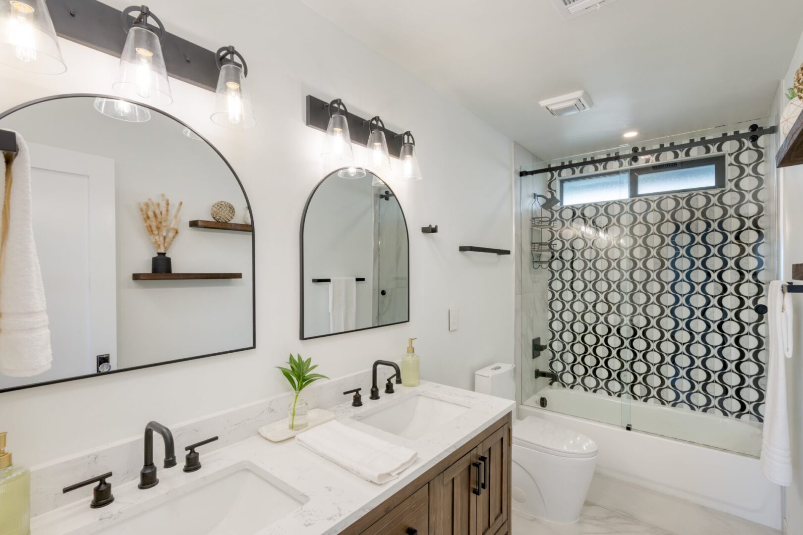 A bathroom with two sinks and a shower.