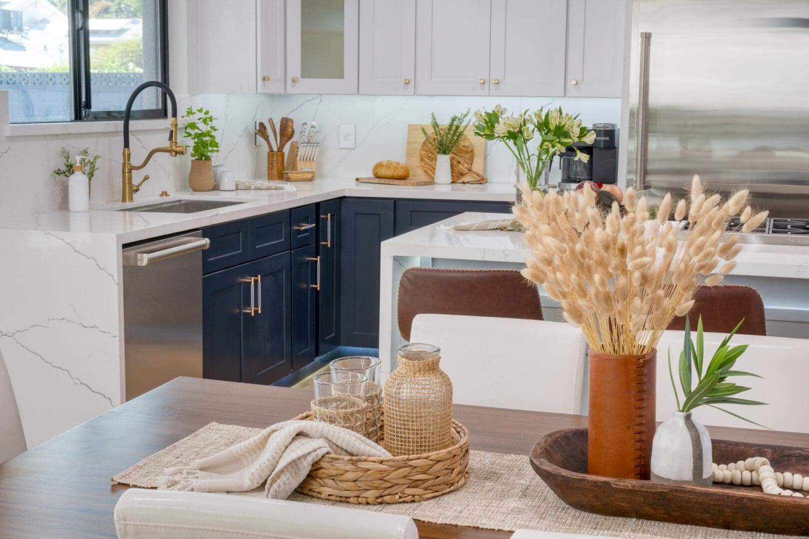 A kitchen with white cabinets and brown counter tops.