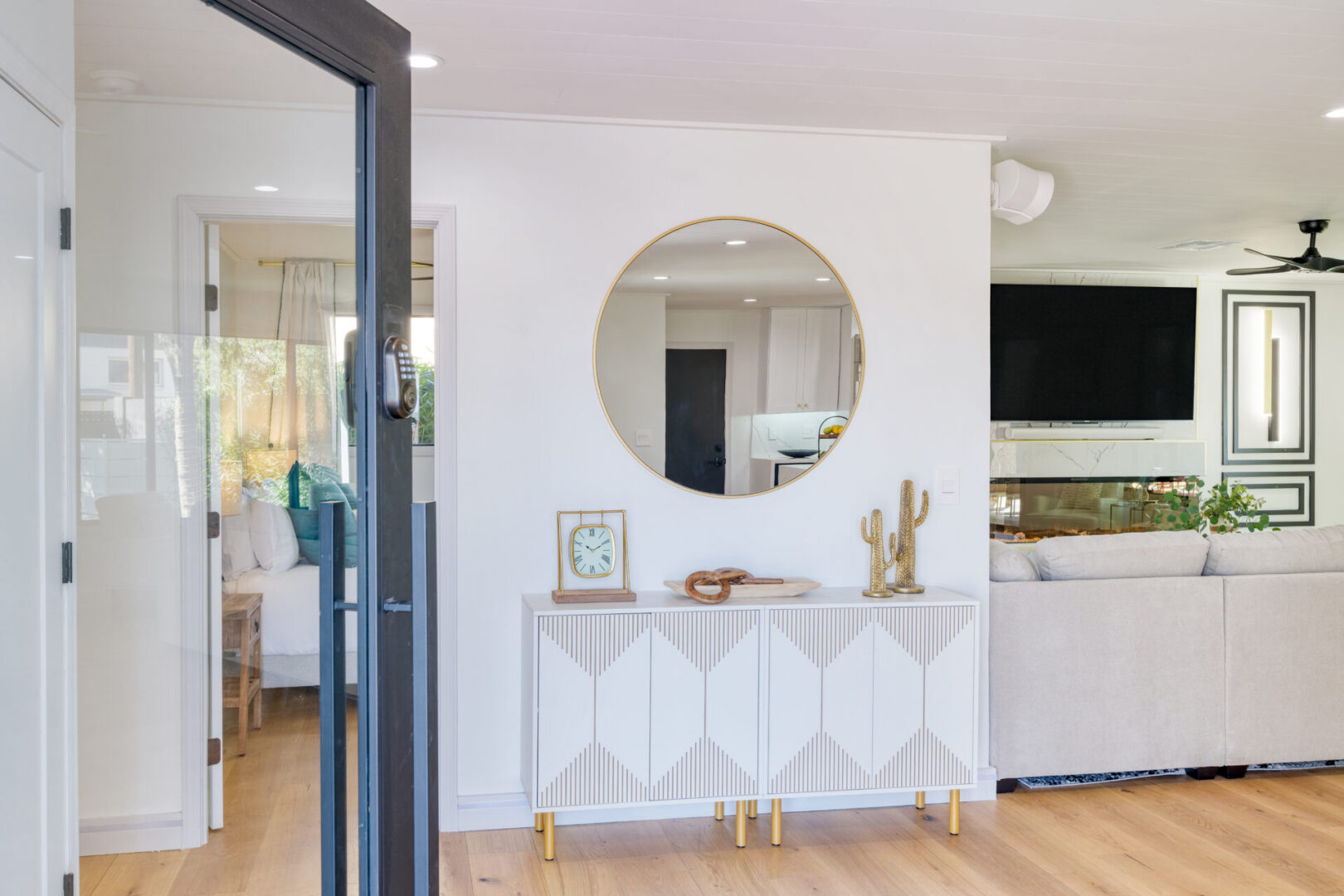 A white table with gold accents in front of a mirror.