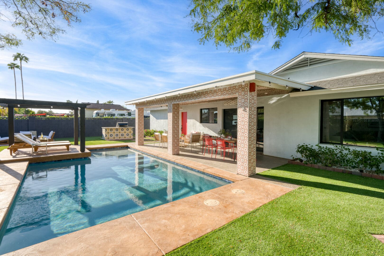 A pool with an open air patio and covered area.