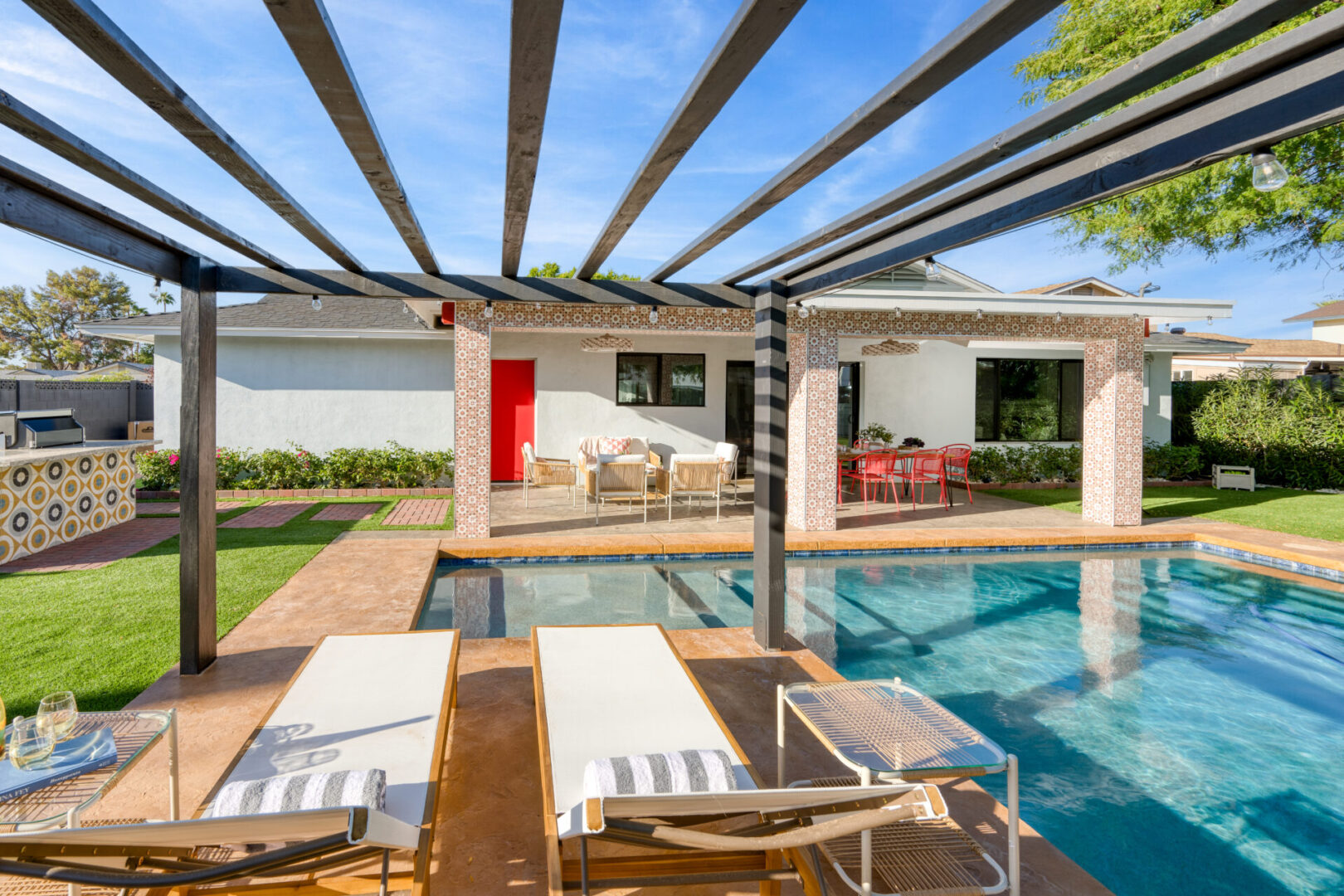 A pool with a covered area and chairs