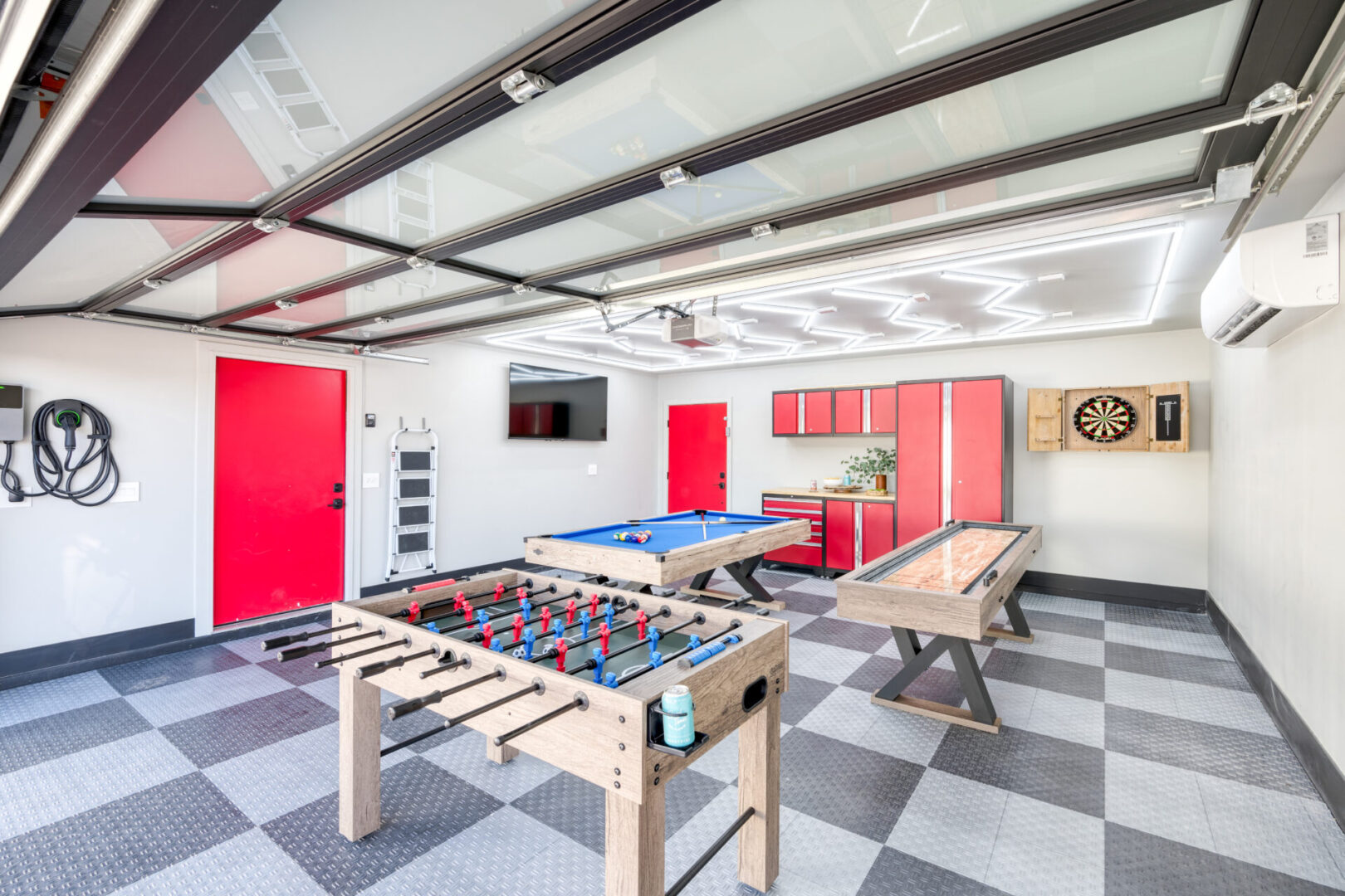 A room with two tables and a pool table.