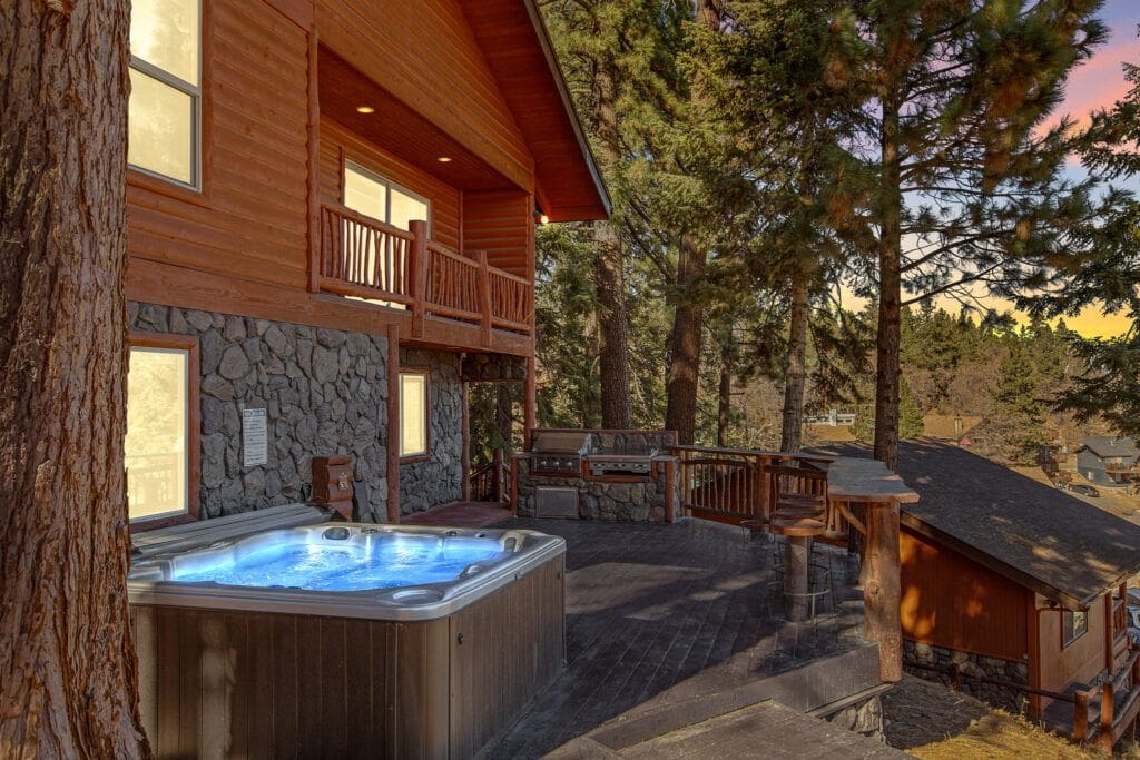 A large hot tub in the middle of a yard.